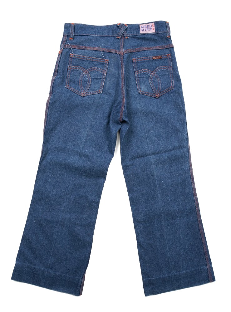 Girls' dark blue wide-leg jeans with orange contrast stitching and heart-shaped back pockets, back view on white background